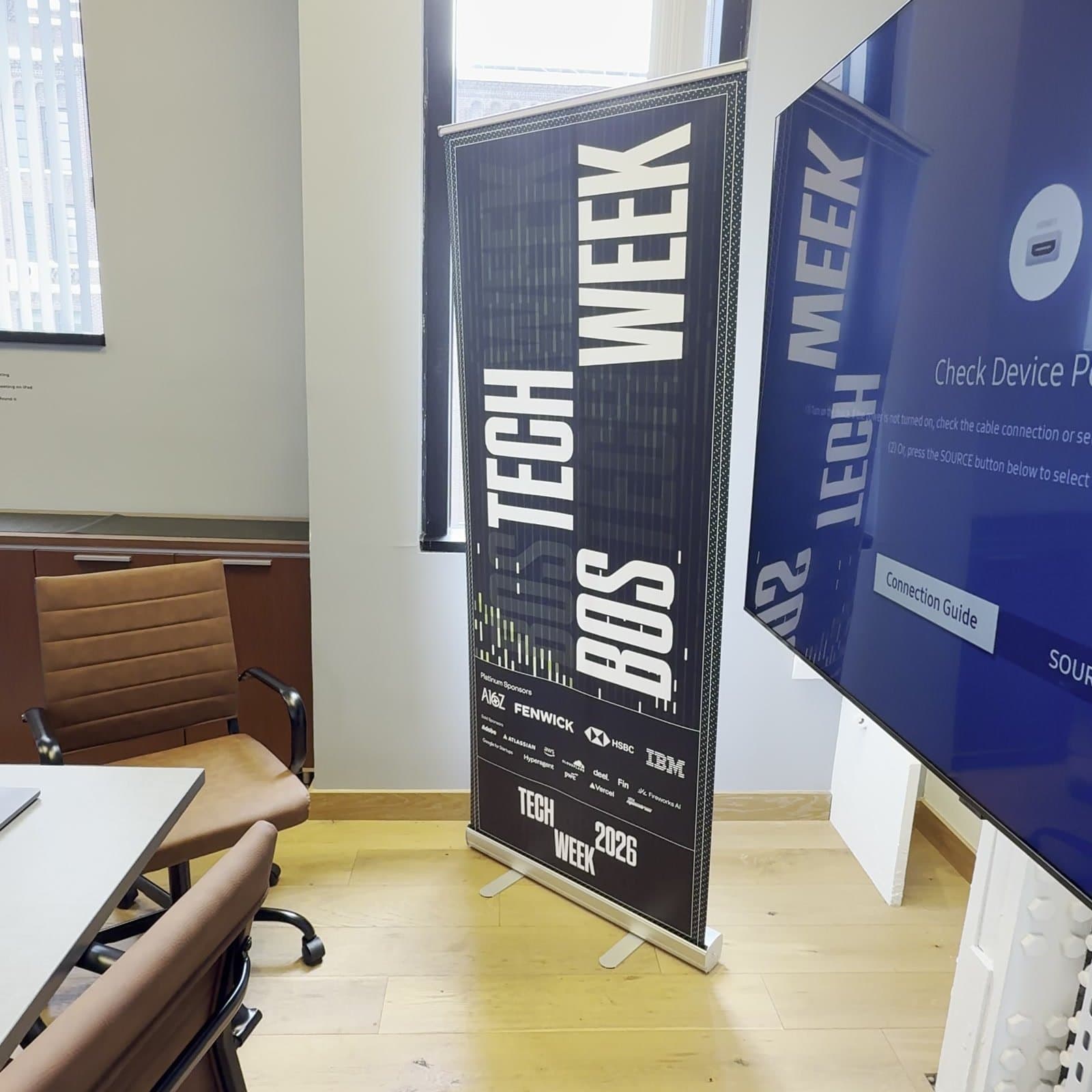 The #BOSTECHWEEK 2026 banner in the room
